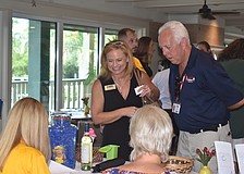 Audra Snyder and Rick Huylebroeck sign in for the event.