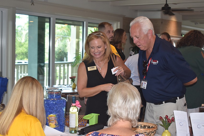 Audra Snyder and Rick Huylebroeck sign in for the event.