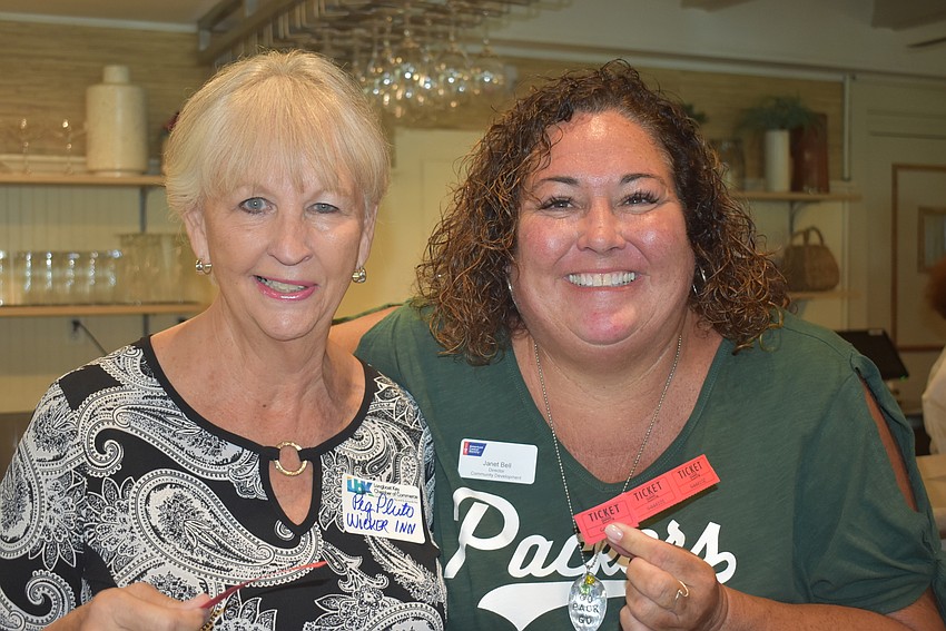 Peg Pluto and Janet Bell, the latter of whom was selling raffle tickets at the evemt.