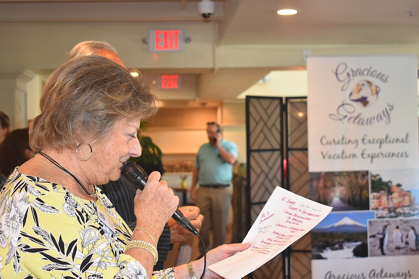 Gail Loefgren mentions Al Benincasa's birthday while the man himself stands in the background making a call.