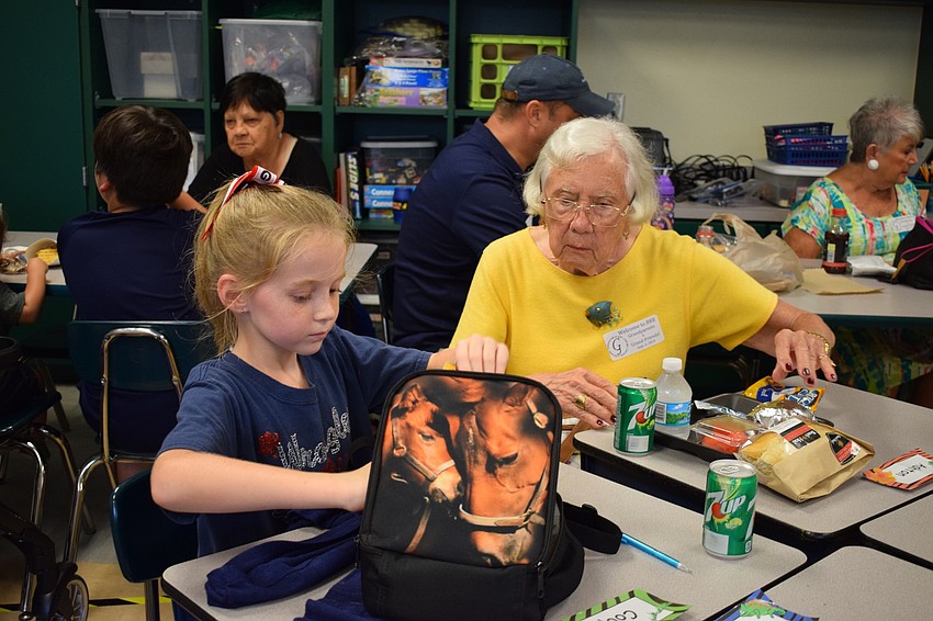 Braden River Elementary School second-grader Cooper Eidson, 7, enjoys lunch with her great-grandmother, Jo Rita Stevens, during a grandparents and grand-friends luncheon.