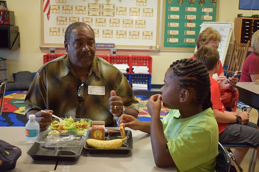Braden River Elementary School fourth-grader Brenda Smith, 9, talks to her grandfather Rozell Foster during a grandparents and grand-friends luncheon at the school.