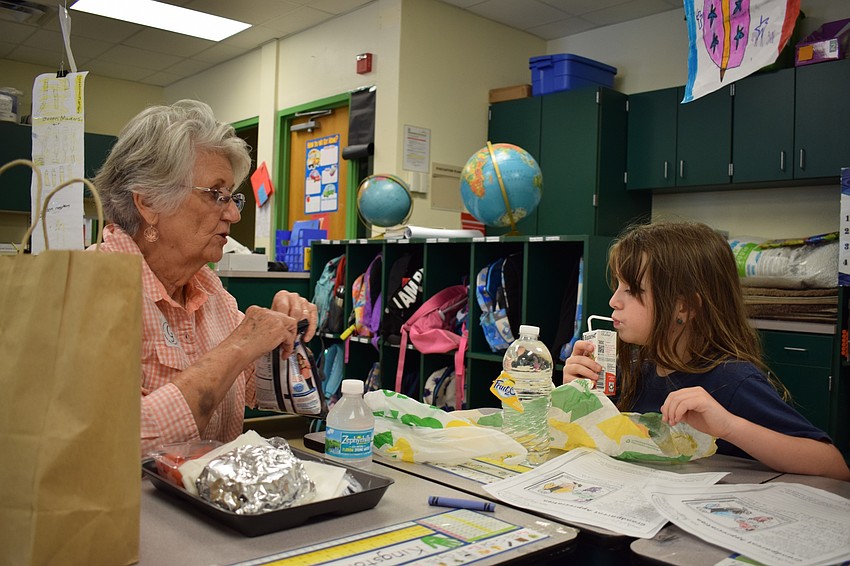 Braden River Elementary School second-grader Annie Schroeder, 7, right, eats lunch in her classroom with her grandmother Sandy Rose during a grandparents and grand-friends luncheon at the school.