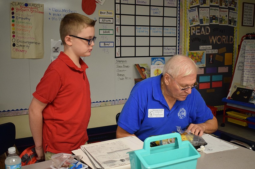 Braden River Elementary School fifth-grader AJ Roeterdink, 10, finishes lunch with his grandfather Richard Vaske.