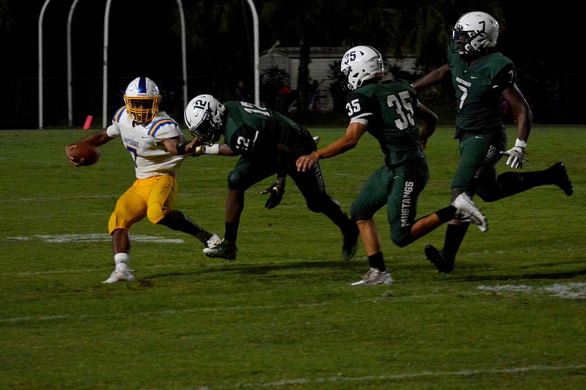 Lakewood Ranch defenders Terrance Williams (12), Sami Ben-Ghuzzi (35) and Dasani Robinson (7) chase down Bayshore quarterback Brian Coleman.