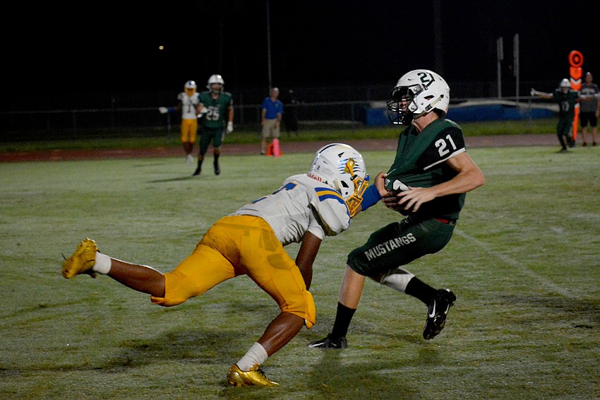 Lakewood Ranch junior cornerback Clayton Hoffman spins from a defender after snagging an interception.