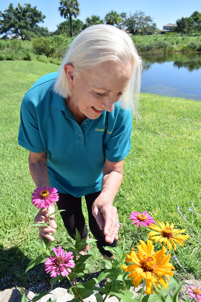 Carolyn Lowry-Nation checks out flowers in her Esplanade back yard.