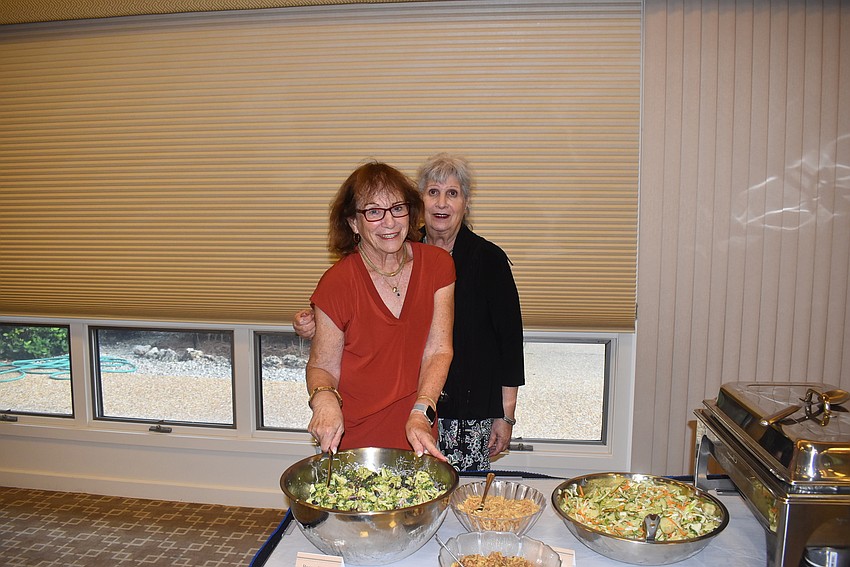 Robin Green and Sylvia Pastor pose with their food.