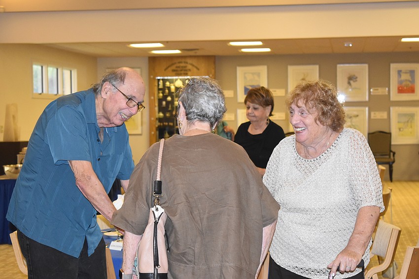 Roy Diton, Miriam Goldfarb and Helen Diton greet each other.