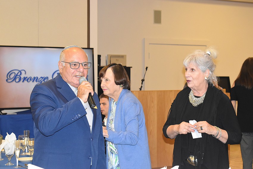 Isaac Azerad and Sylvia Pastor announce dinner.