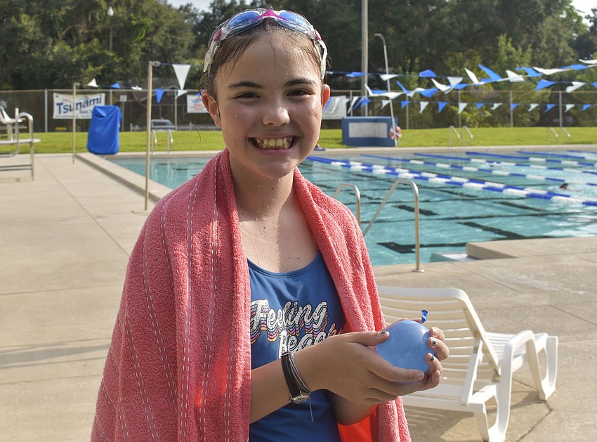 Alexis LaVasseur, 11, waits for the water balloon toss to start.
