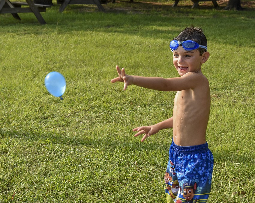 John Kinahan tosses his water balloon.