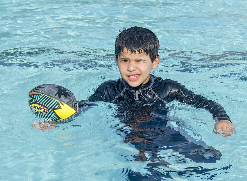 Josh Oleaga poses with his football.