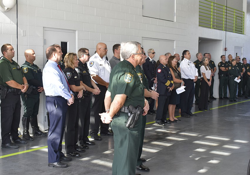 Members from the Sarasota County Fire Department and Sheriff's Office listen to Fire Chief Michael Regnier's speech.