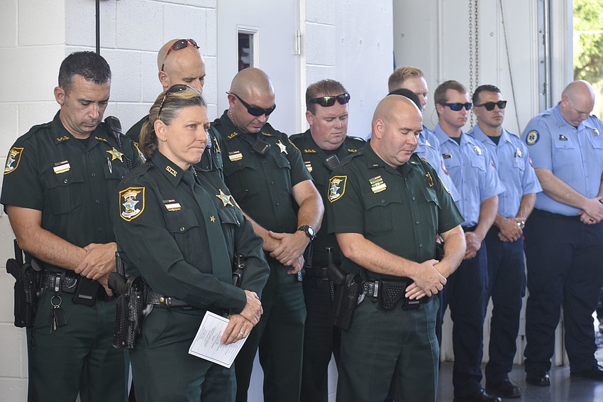Members of the Sarasota County Fire Department and Sheriff's Office recognize the moment of silence.