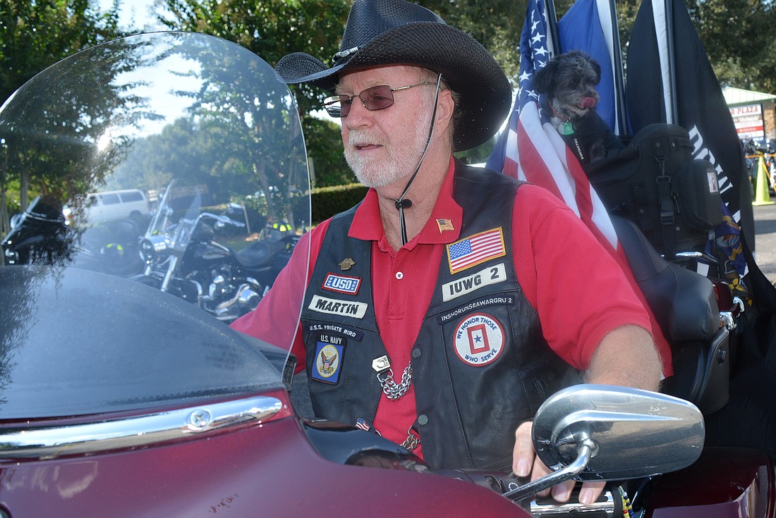 U.S. Navy veteran Les Martin leads the motorcycle parade  from the parking lot in front of Naughty Monk Brewery.