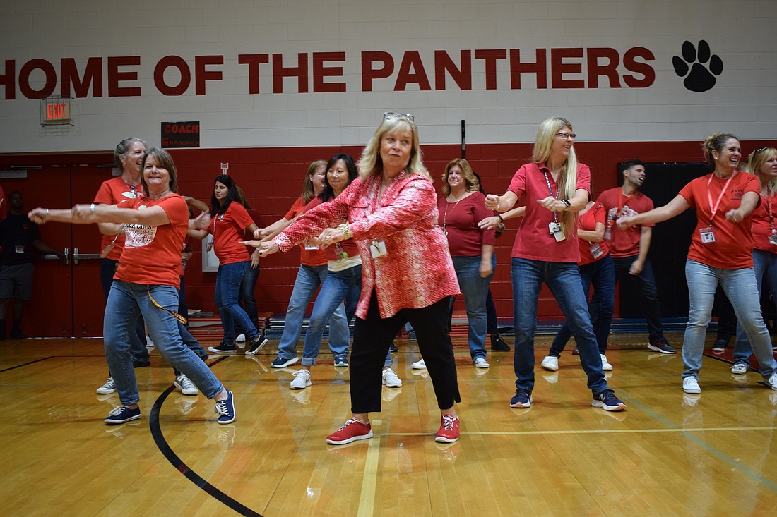 From front left, Braden River Middle School teachers and staff Jill Bergeron, Lannette Gillen, Heidi Enneking and Patty Sisson dance with other teachers and staff during the school&#39;s first Renaissance assembly of the year.