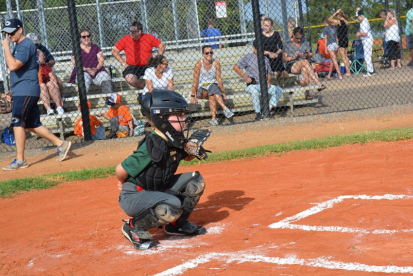 East County's Jace Brush isn't used to wearing catcher's gear, but adapts well.
