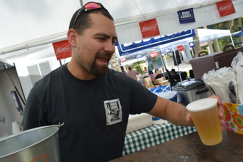 Linger Lodge's Aland Negrin serves beer, lemonade and barbecue from a riverside stand.