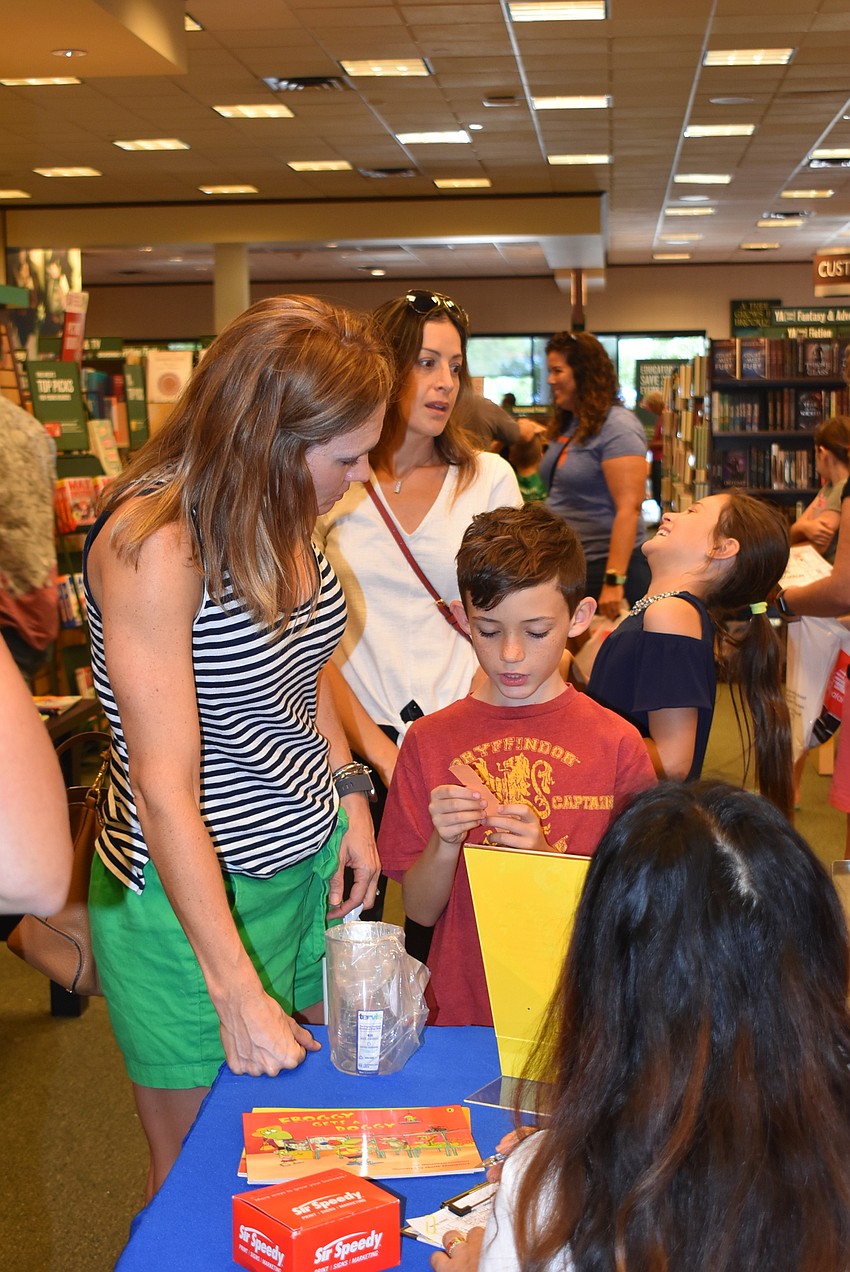 Mindy and Ethan Kirsch get signed up for the book fair.