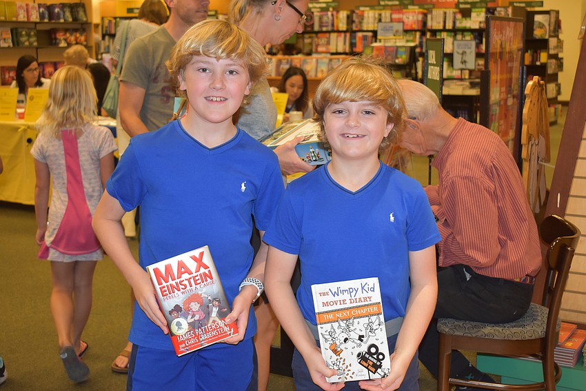 Jeffrey and Justin Anderson with their books.
