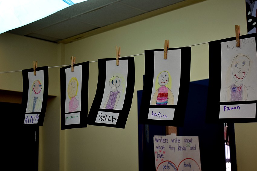 The first grade classroom is decorated with self  portraits.