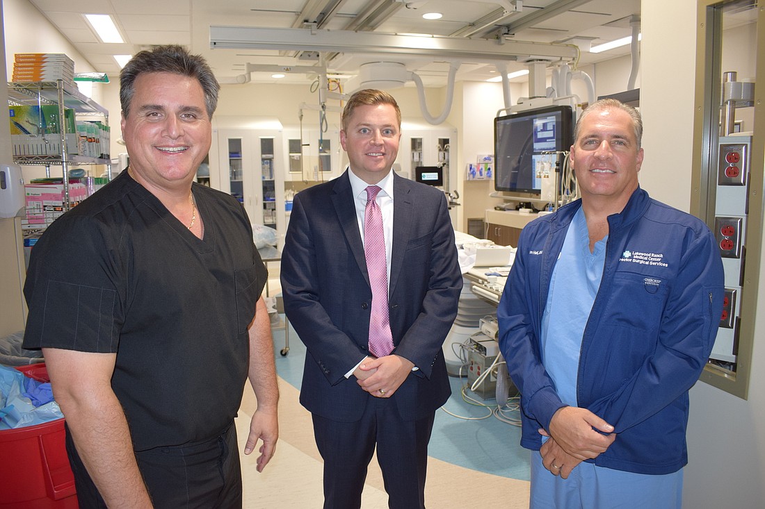 Dr. Richard Aranibar, CEO Andy Guz and Director of Surgical Services John Hall stand in front of the new cardiac catheterization lab.