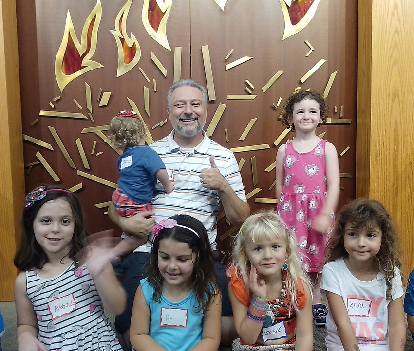 Temple Emanu-El Associate Rabbi Michael Shefrin welcomes children to the pulpit.