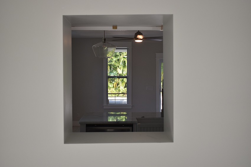 A view from the back room through the kitchen and the front porch.
