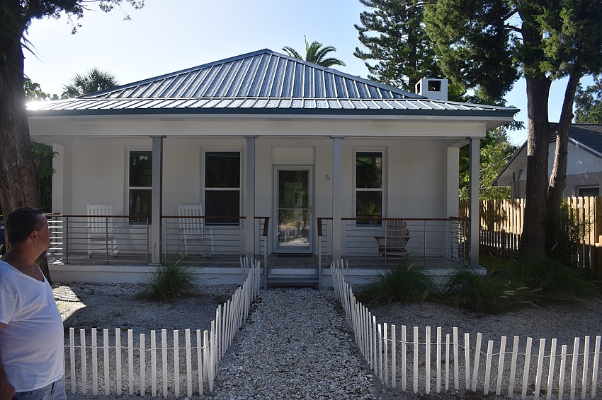 James Sebastiano in the front yard, which features northeast-style beach fencing.