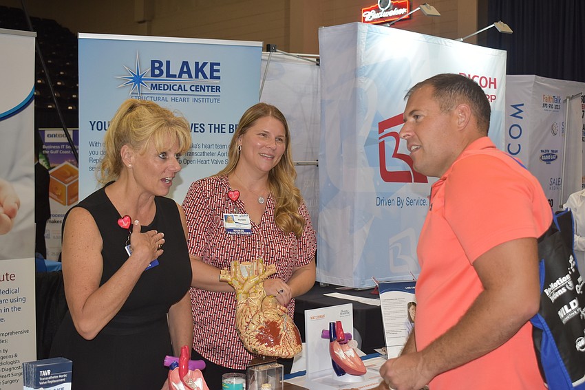 Mary Goyak and Renee Saboya explain their booth to Nathan Horner.