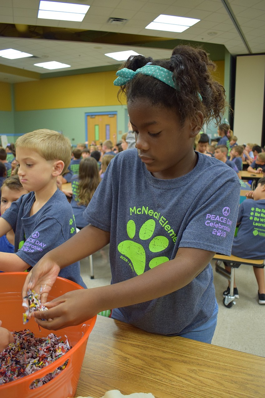 Gilbert W. McNeal Elementary School second-graders Haven Wiley, 7, front, and Deacon Hauenstein, 7, make seed balls during an activity to celebrate International Peace Day.