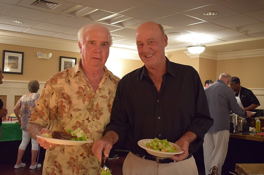 Tom Bretzius, left, and Bob Gilbert, right, enjoy Italian food during Tara Golf and Country Club's annual San Gennaro Festival.