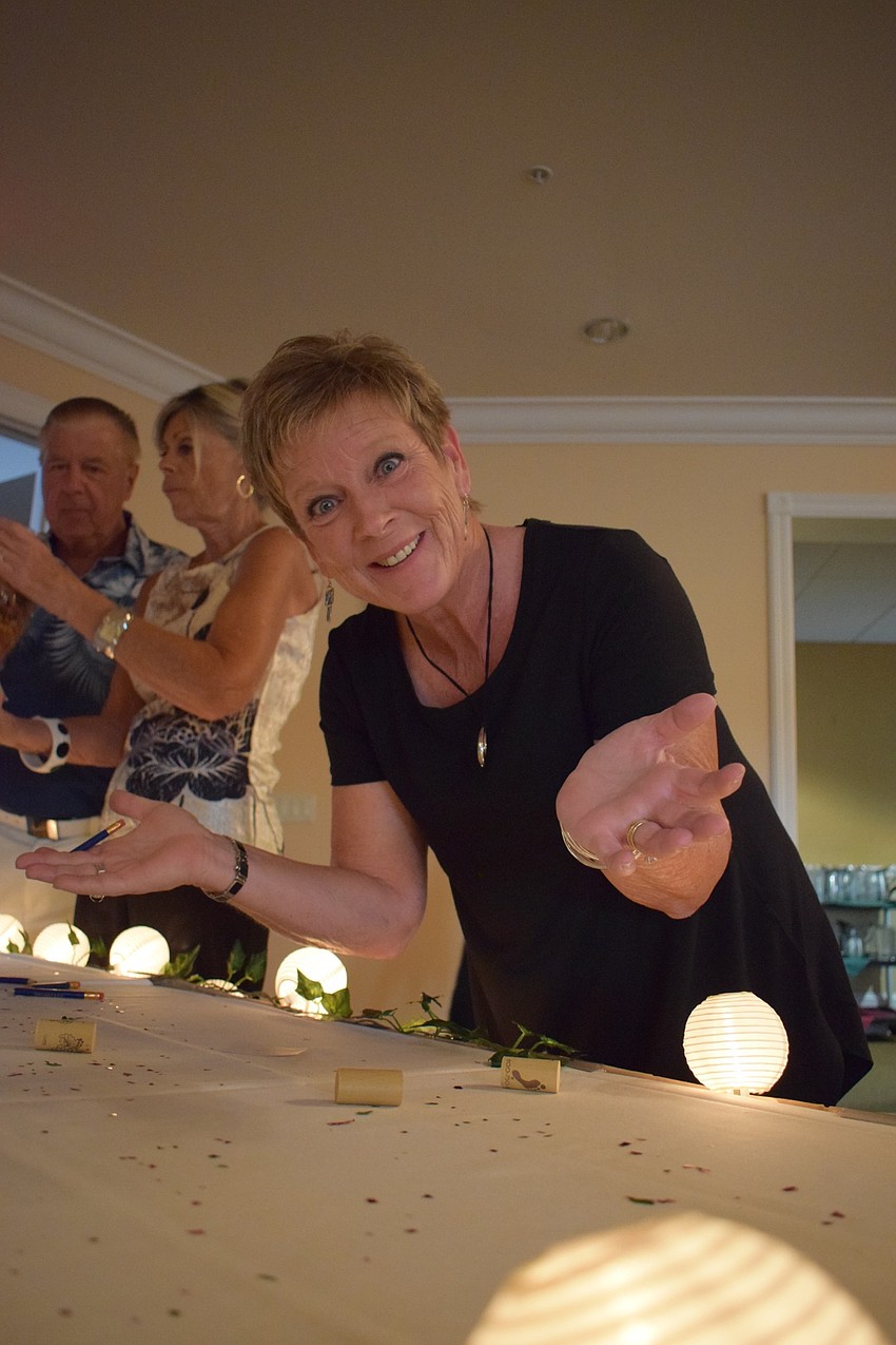 Deb King hopes for the best as she guesses how many pieces of pasta are in a container during the annual San Gennaro Festival at Tara Golf and Country Club.
