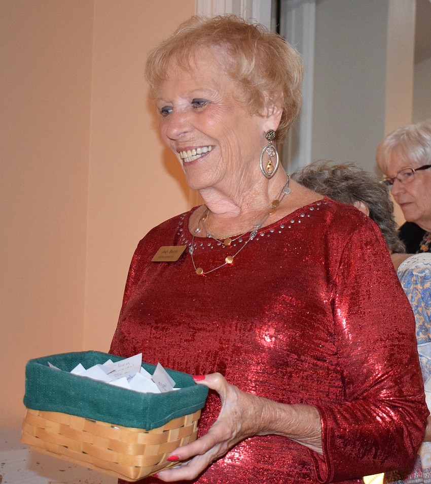 Tara Golf and Country Club's Judy Harris collects guesses for how many pieces of pasta are in a container during the San Gennaro Festival at the club.