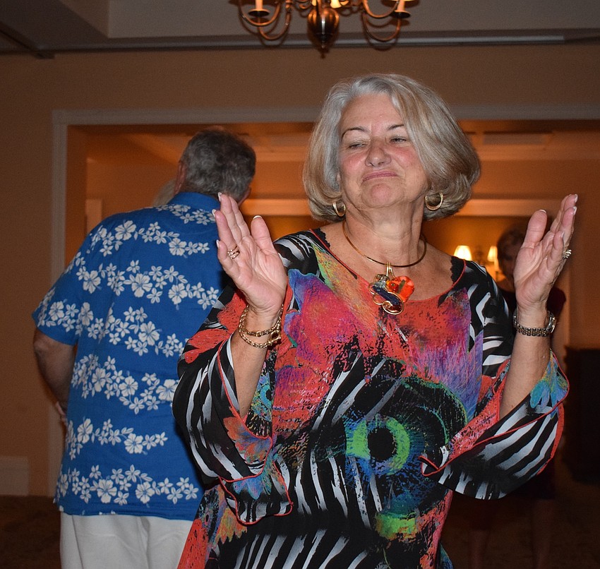 Tara resident Linda Barber dances and claps along to the beat during the San Gennaro Festival at Tara Golf and Country Club.