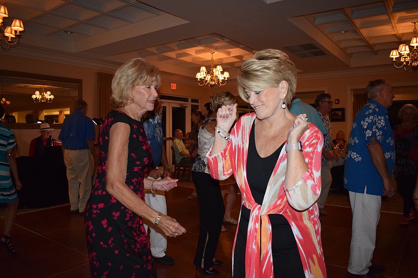 Tara residents Kristin Kaufman, left, and BJ Cameron, right, dance together at the San Gennaro Festival at Tara Golf and Country Club.