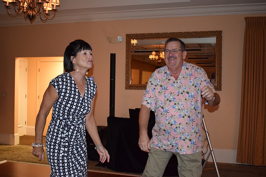 Robin Bessire, left, and Phil Parsch, right, dance together during the San Gennaro Festival at Tara Golf and Country Club.
