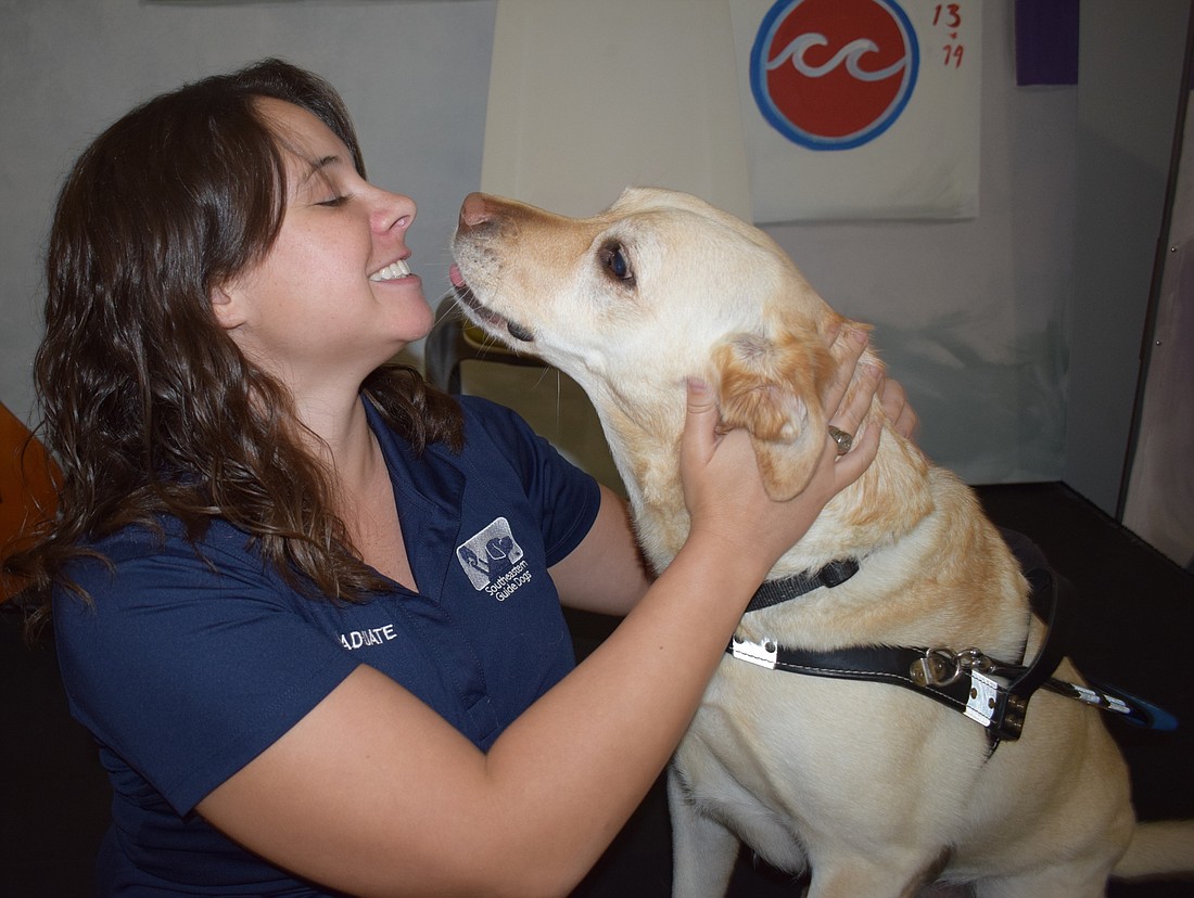 East County&#39;s Katie McCoy plays with her guide dog, Bristol.