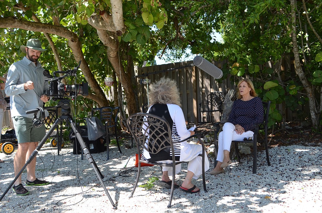 Chucha Barber interviews Manatee County Commissioner Carol Whitmore at MarVista Dockside in Longboat Key. Cinematographer/editor Josh McLawhron works to get the sound and images just right.