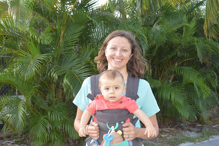 Taylor Thoma holds Aspen, the youngest member of the cleanup.