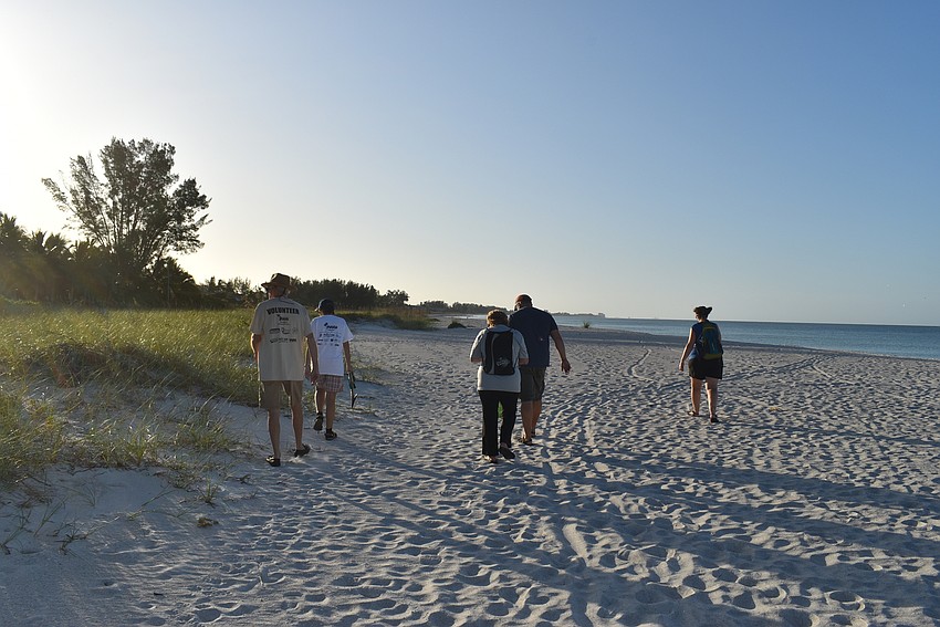 Peter and Olga Stokes, Dawn DiFoggio and Charles and Karey Kaine head down the beach.