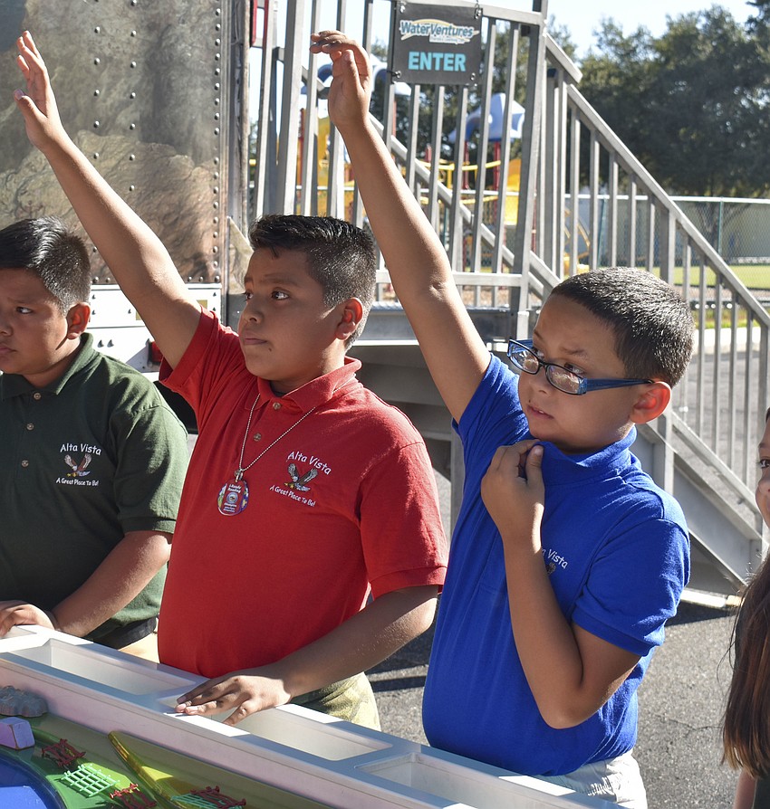 Jonathan Lopez and Giovanni Strickland wait to answer a question about different gases that affect the environment.