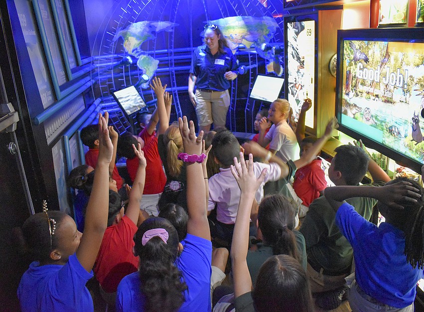 The fifth graders anxiously wait to answer a question.