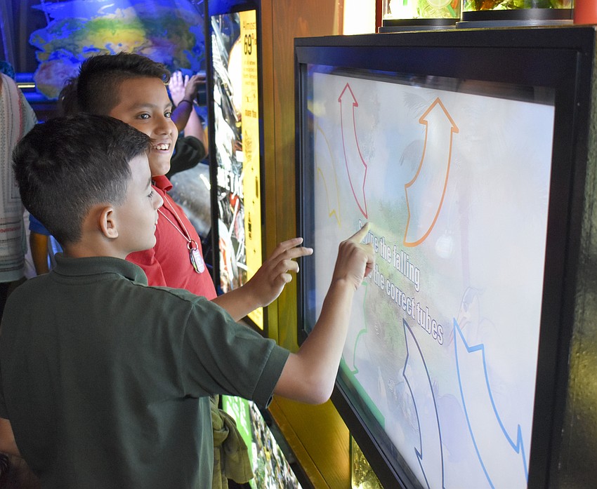 Jonathan Lope and Jaeiel Rosado interact with one of the stations.
