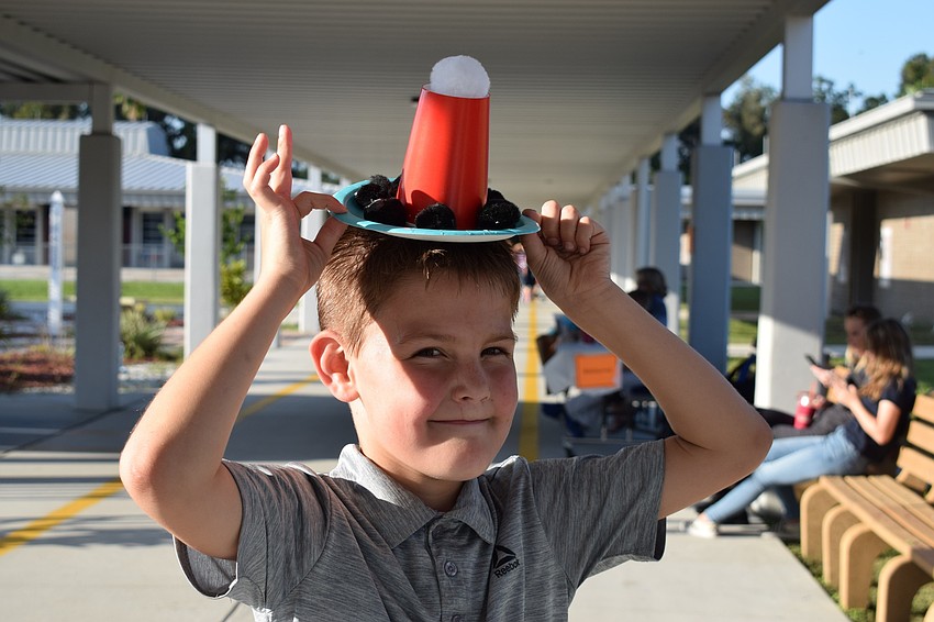 Second-grader Blake Swann, 7, places his hand-made sombrero on his head. Swann had so much fun at last year's Hispanic Heritage Night, he wanted to come back for more this year.