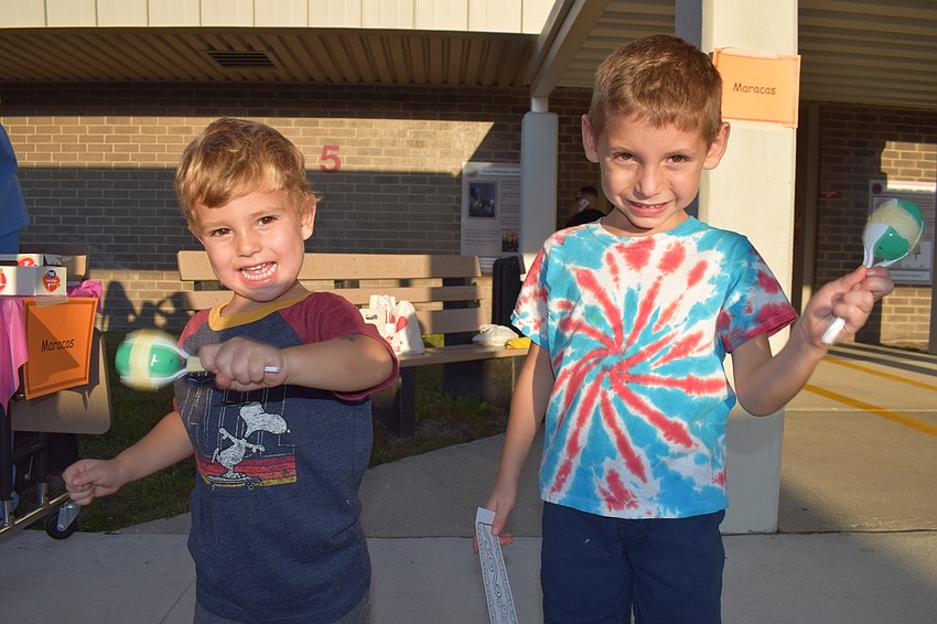 Kindergartner Maxwell Stephenson, right, and his 2-year-old brother Bennett, shake the maracas they made out of plastic spoons and plastic eggs filled with beans.