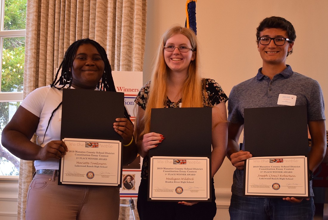 From left, Lakewood Ranch High School senior Mariette Tomlinson, Braden River High School senior Madigan Wilford and Lakewood Ranch High School senior Joey Robertson beam with pride claiming the top prizes in the essay contest.