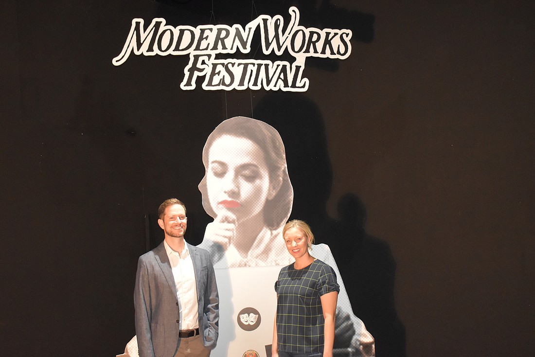 Brendan Ragan and Summer Wallace in the Urbanite theatre with the backdrop for the Modern Works Festival.