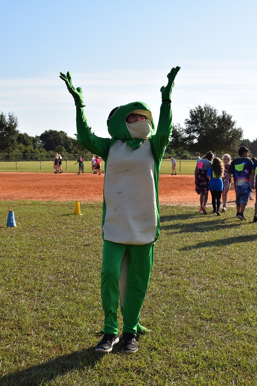 Parent Michelle Nungesser dances while dressed as a gecko, which is Robert E. Willis Elementary's mascot. Nungesser says she always wanted to be a mascot, and the school's walk-a-thon was the perfect opportunity.